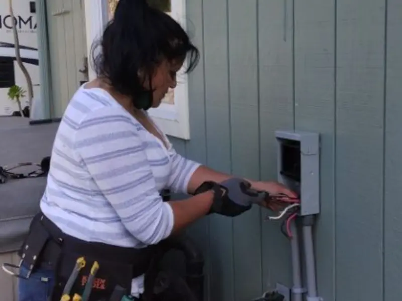 Licensed electrician wiring an exterior subpanel in Manteca